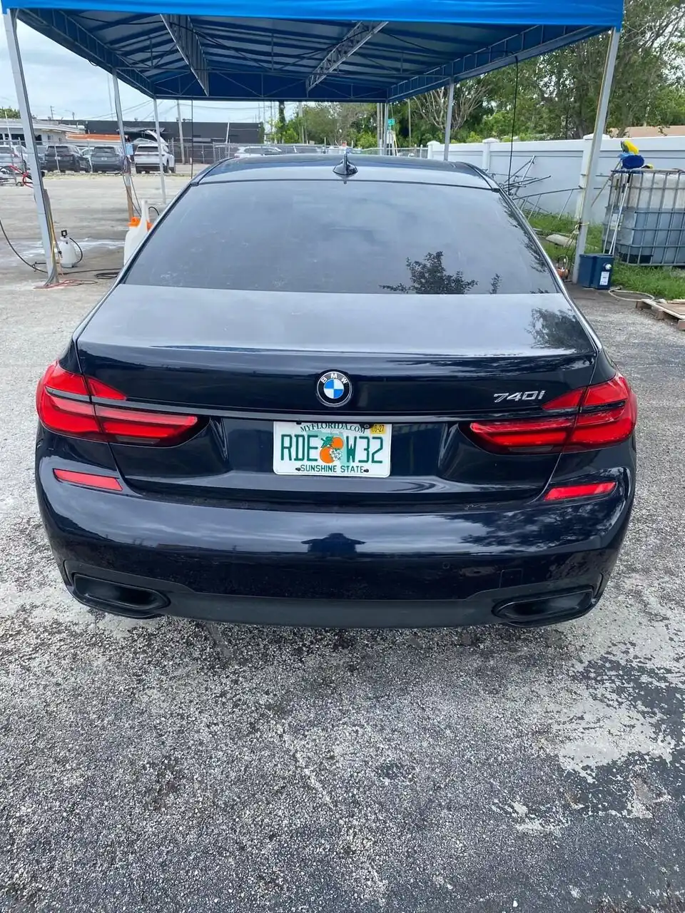Black BMW 7 Series rear view after a full detail