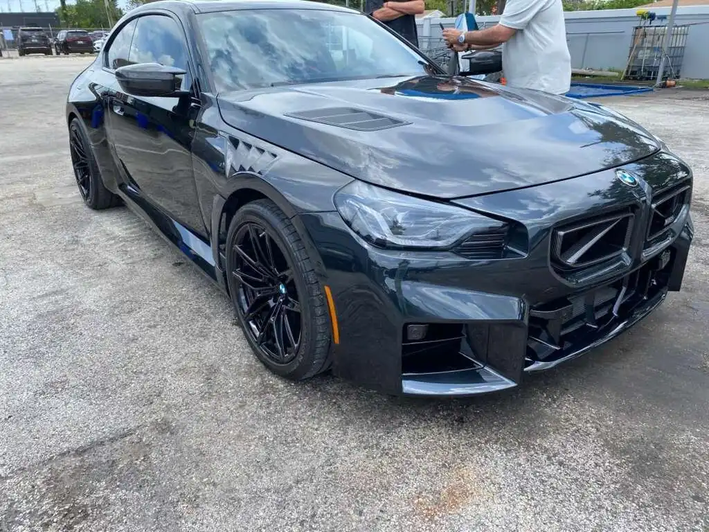 Black BMW M2 getting hand washed by our team