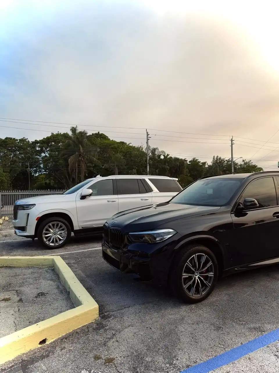 Black BMW X5 side view, glossy finish