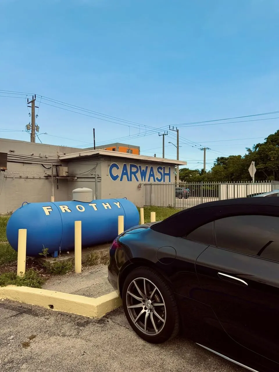 Black sedan parked at the Frothy entrance