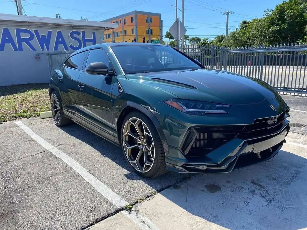 Green Lamborghini Urus parked at the carwash after a full detail