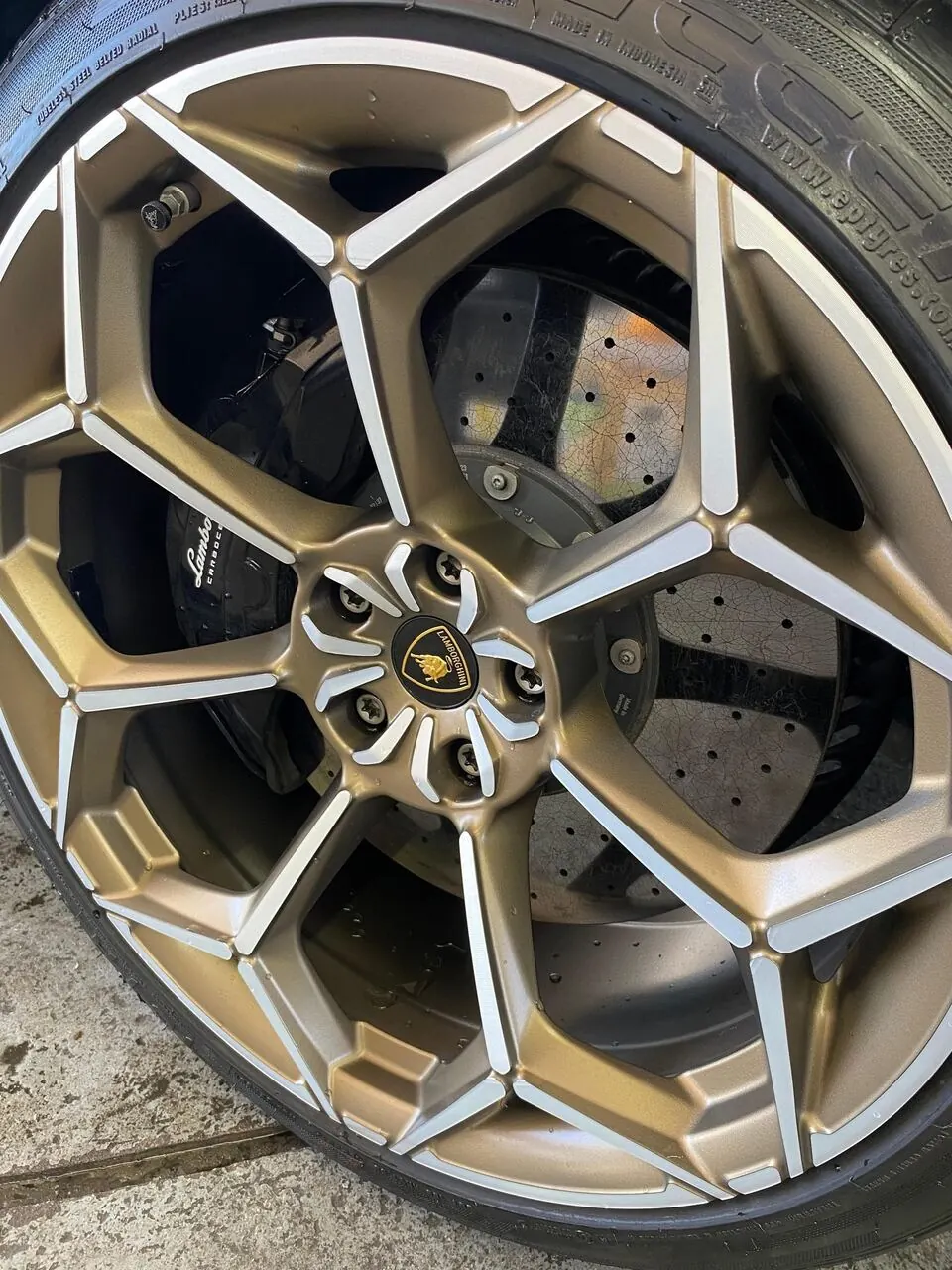 Lamborghini gold wheel and brake caliper close-up