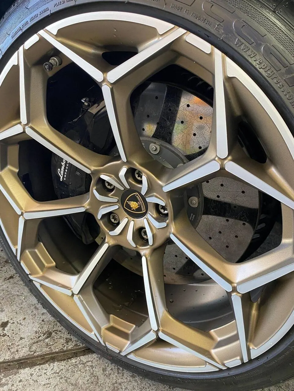 Lamborghini gold wheel and brake caliper close-up