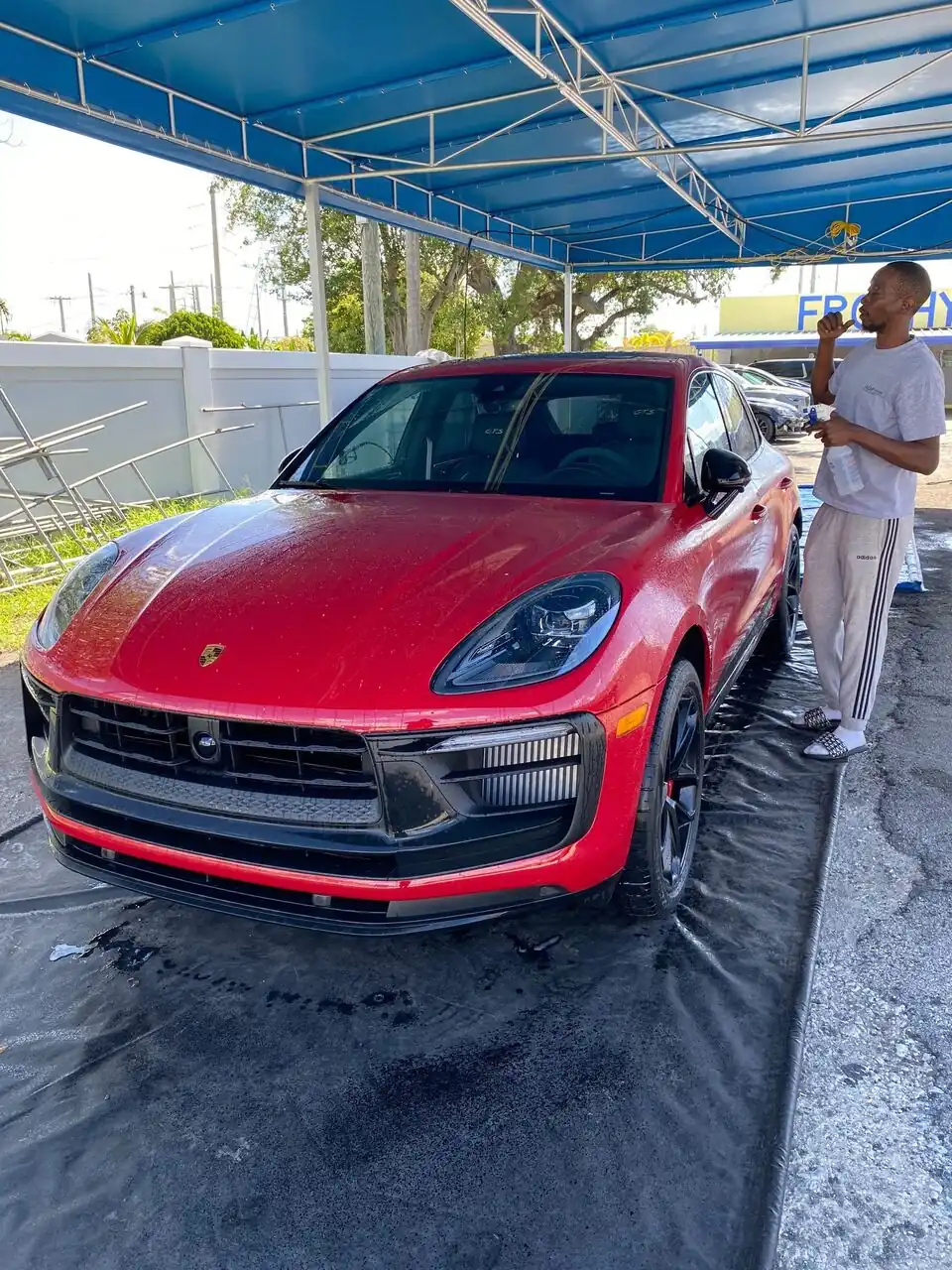 Red Porsche Macan after a hand wash, glossy finish
