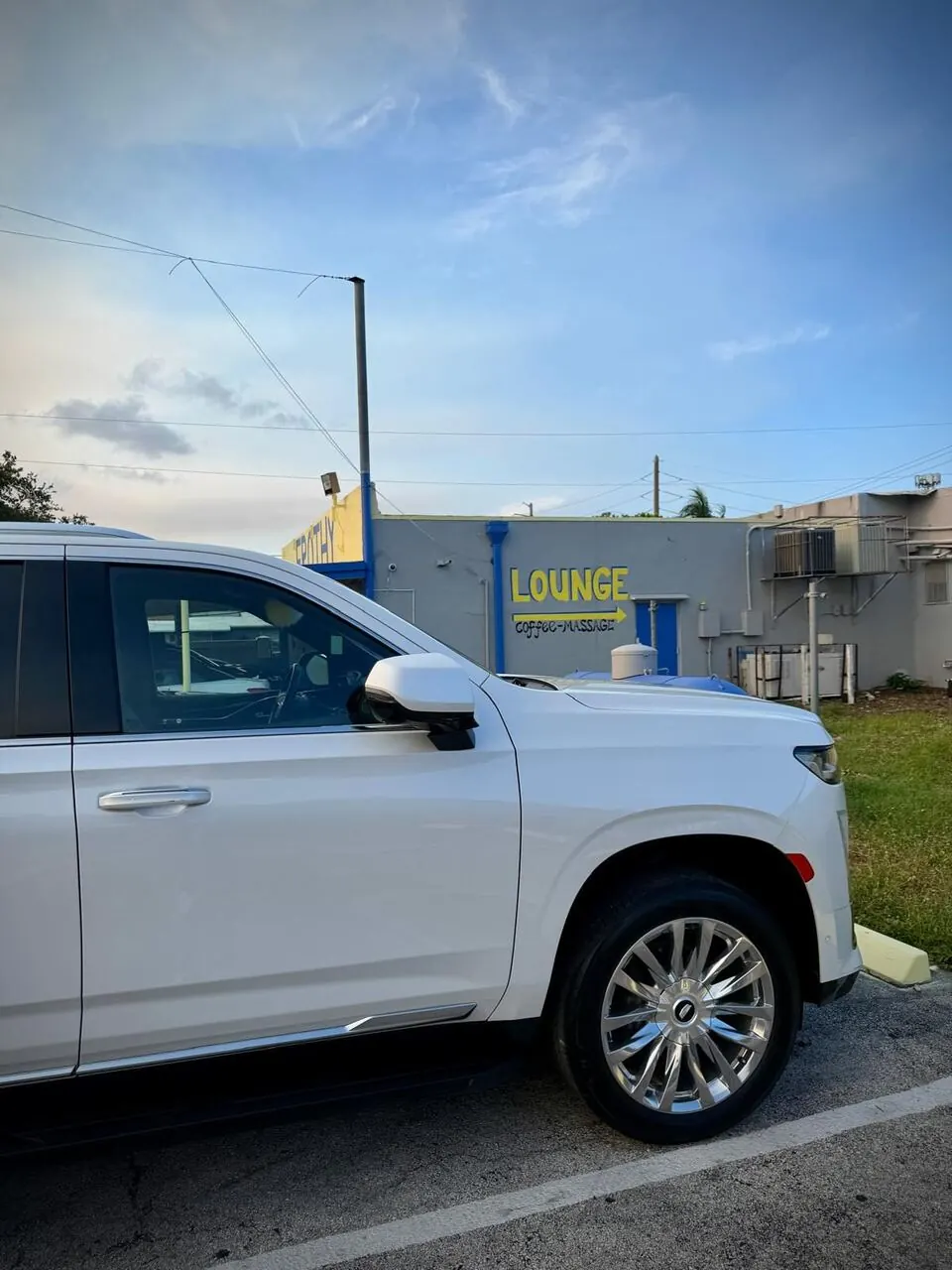 White Cadillac SUV front view, alternate angle