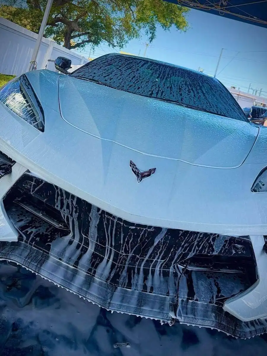 White Corvette covered in foam, front view