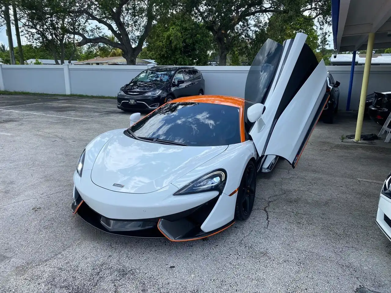 White McLaren 570S with door open during a full detail