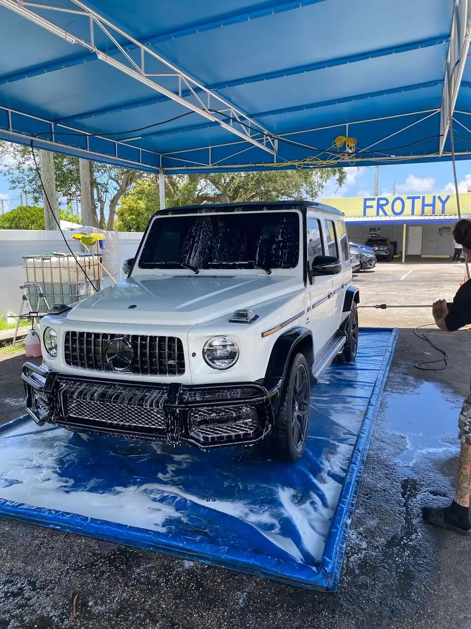White Mercedes-AMG G63 covered in foam during a hand wash