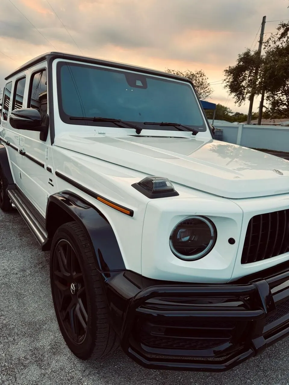White Mercedes-AMG G63 side view, alternate angle
