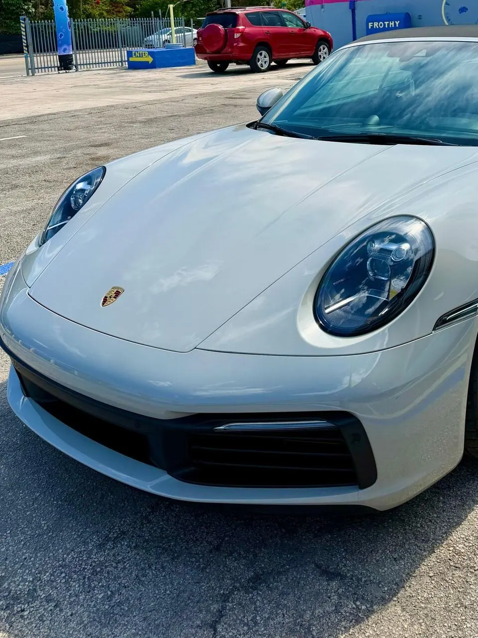 White Porsche 911 front view, alternate close-up